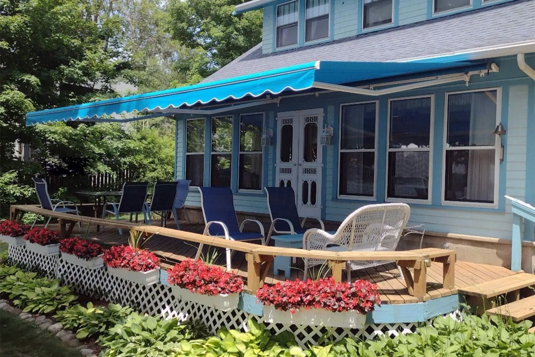 Charming deck with seating and floral decor.