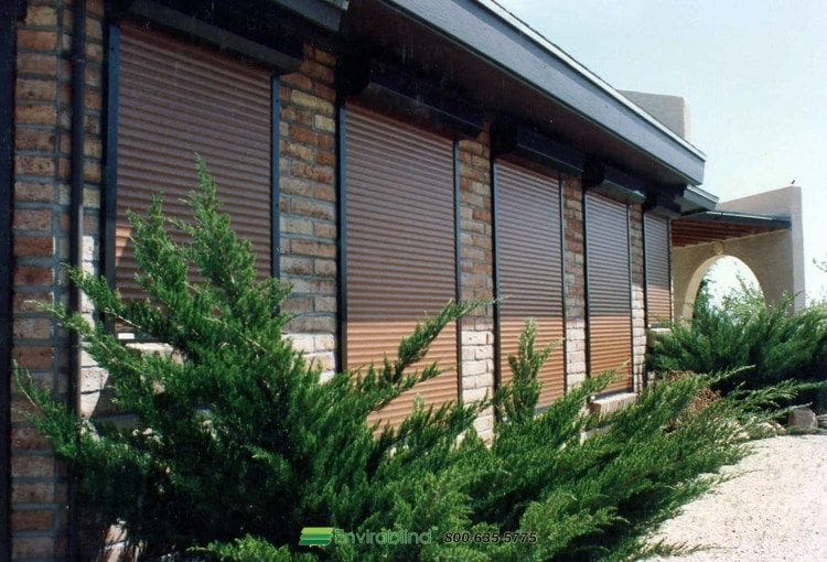 House exterior with brown shutters and plants