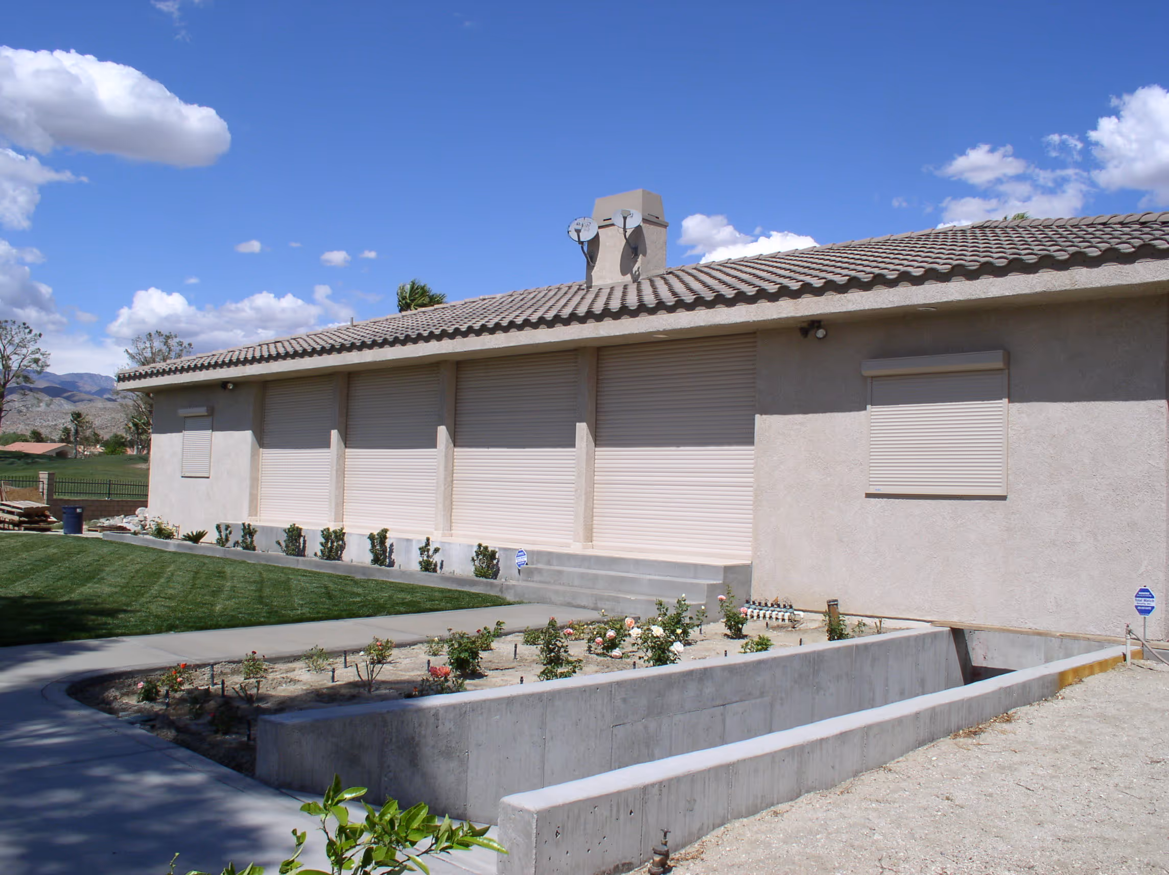 House with closed shutters and garden