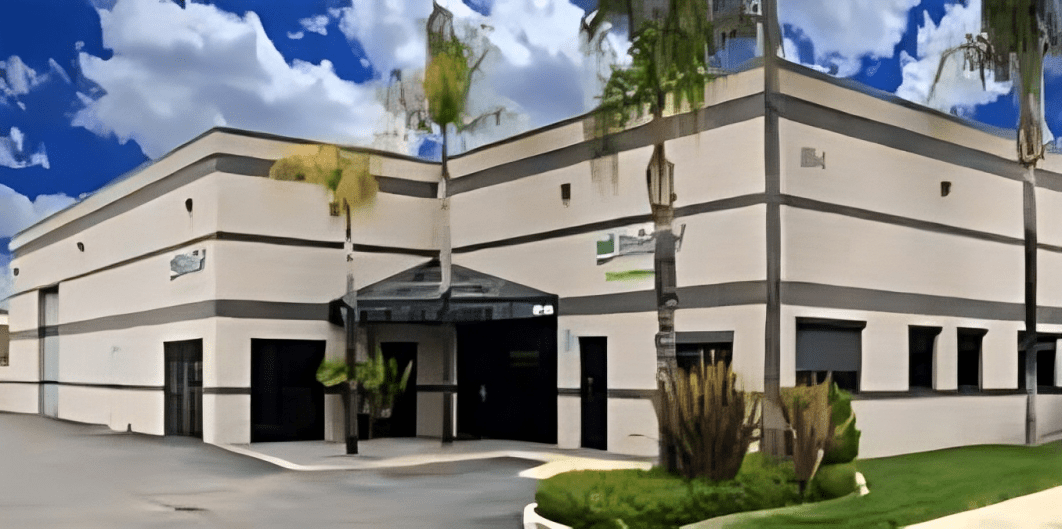 Modern industrial building with palm trees