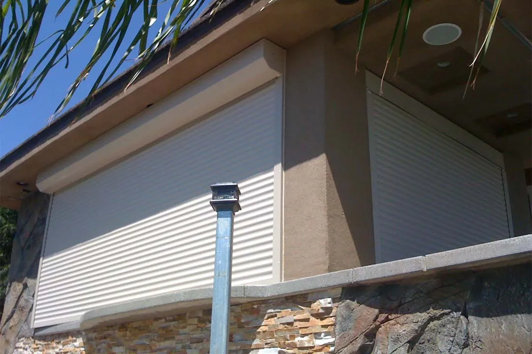 Building with white roller shutters closed