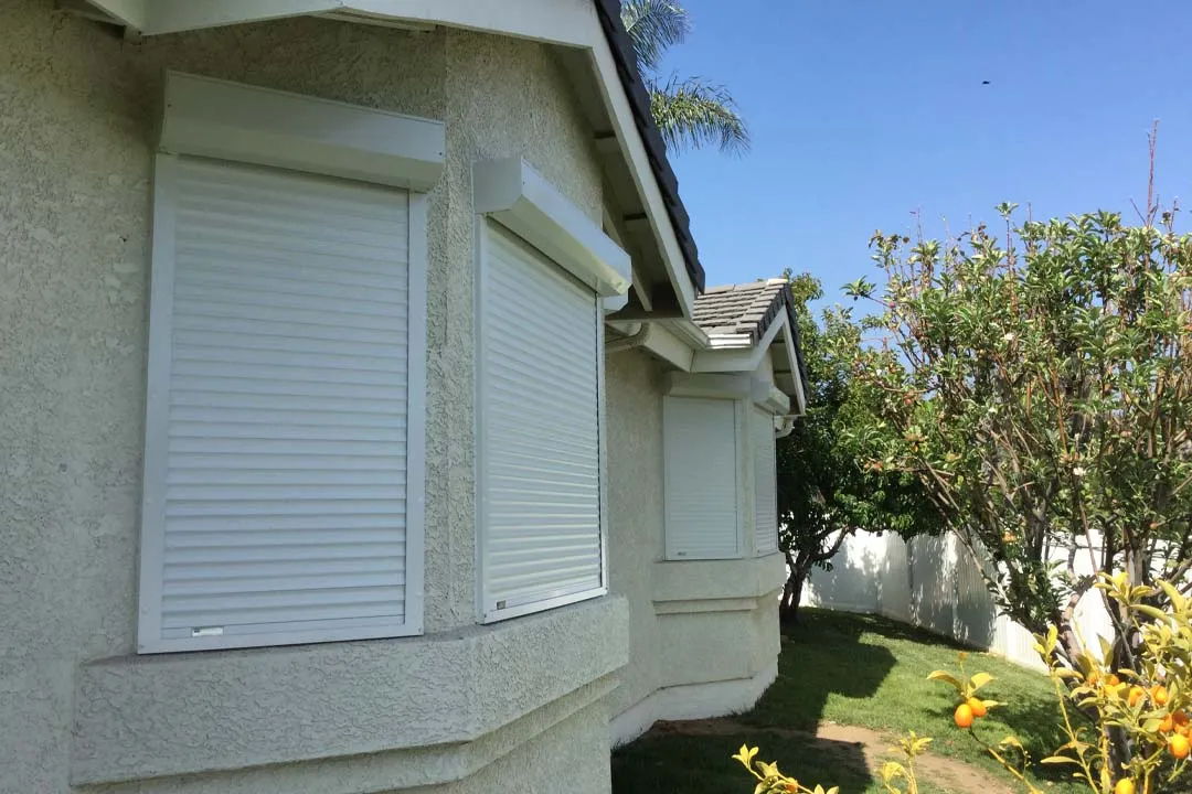 Closed white shutters on house windows