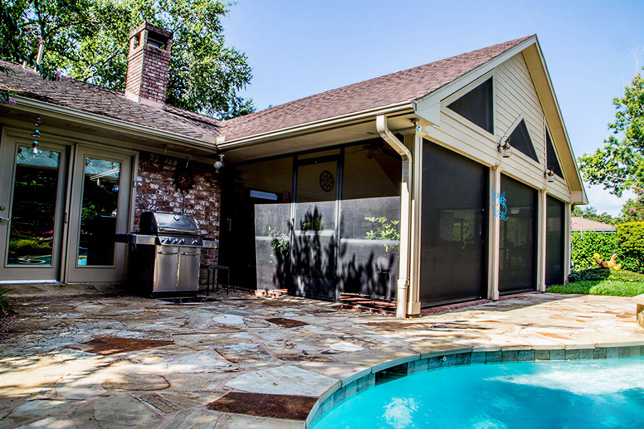 Backyard with stone patio and pool