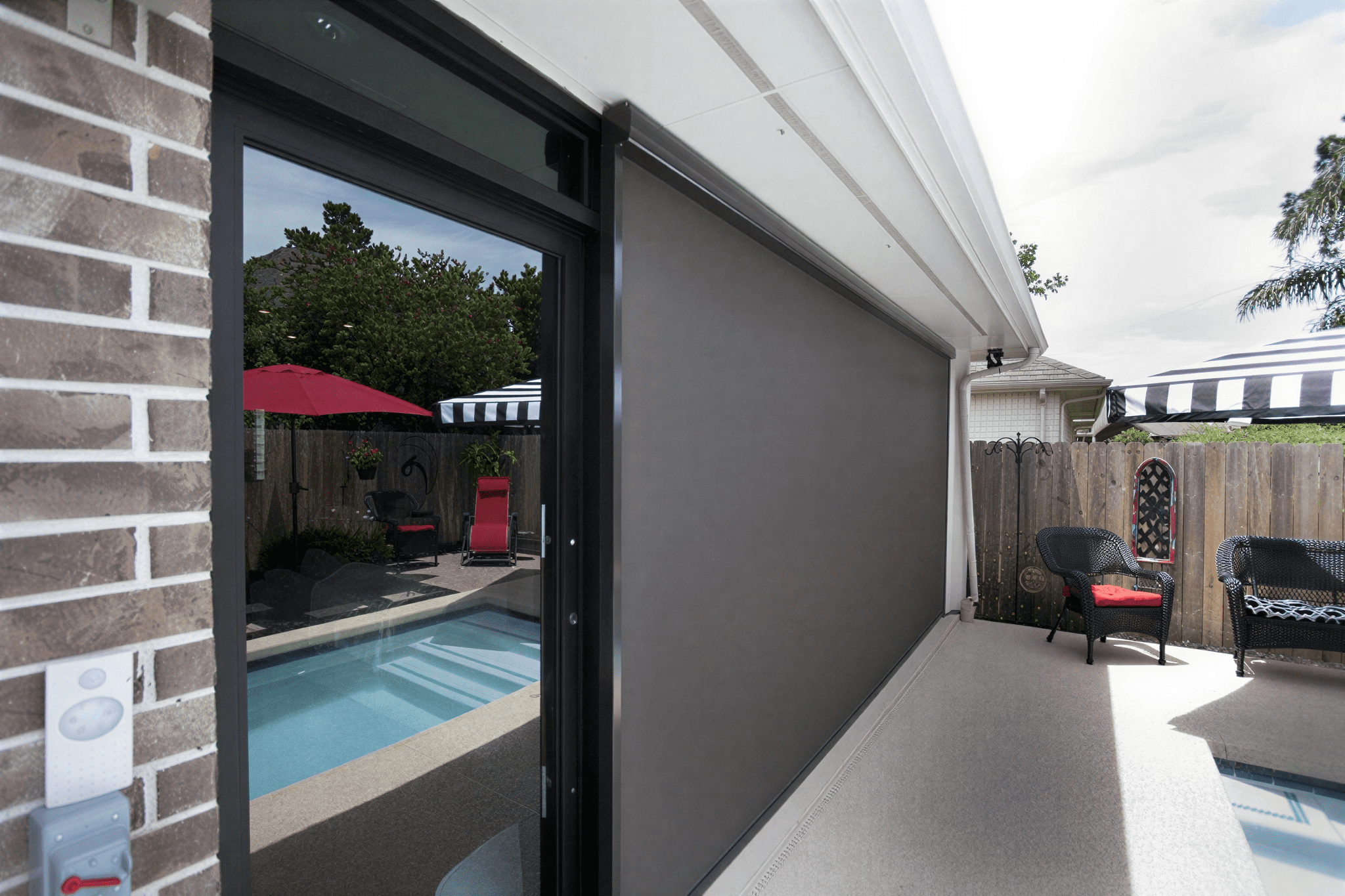 Patio with poolside seating and umbrellas