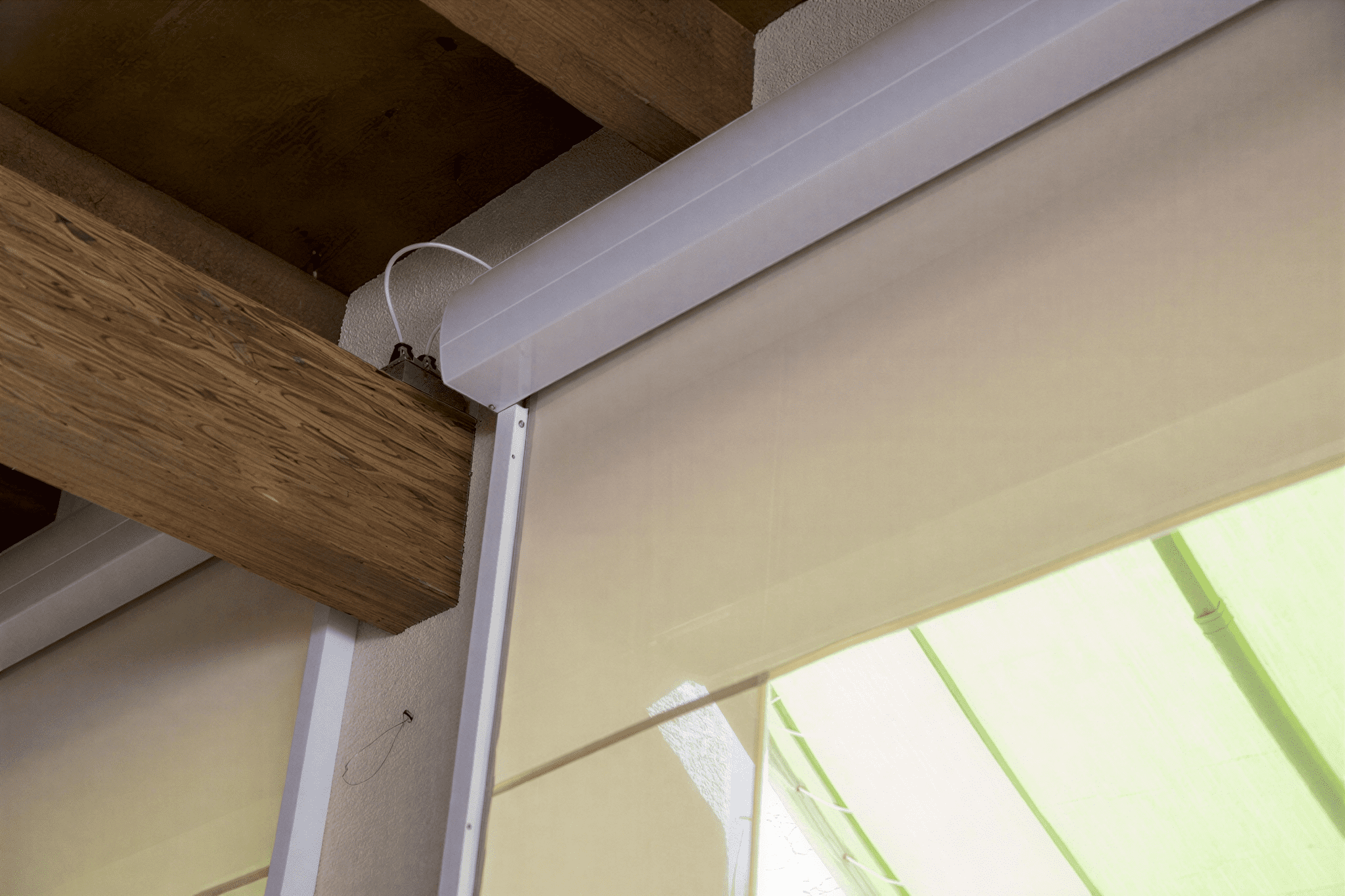 Retractable blinds under wooden structure
