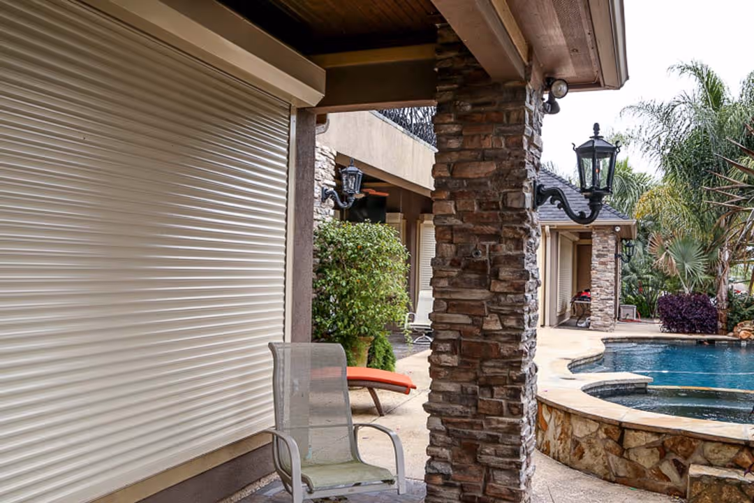Outdoor seating by a closed roller shutter.
