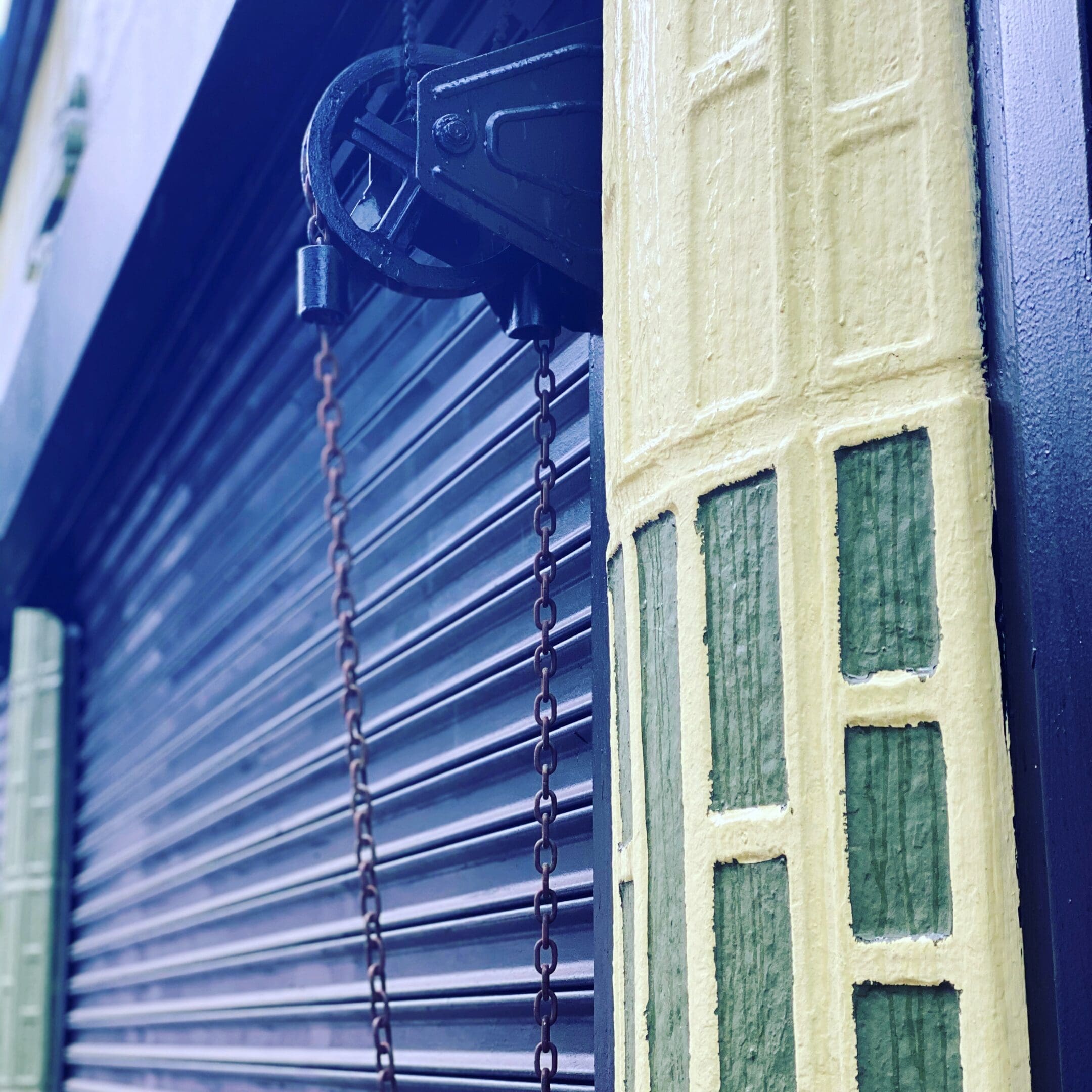 Chain and pulley on building exterior.