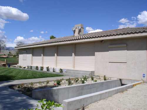 House with closed shutters and garden