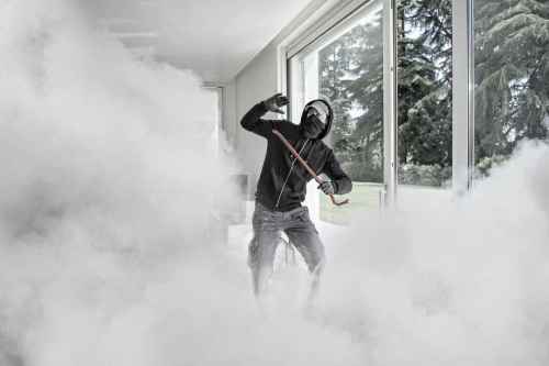 Intruder in foggy room near window.