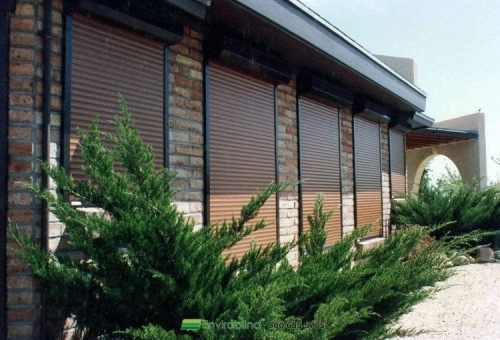 House exterior with brown shutters and plants