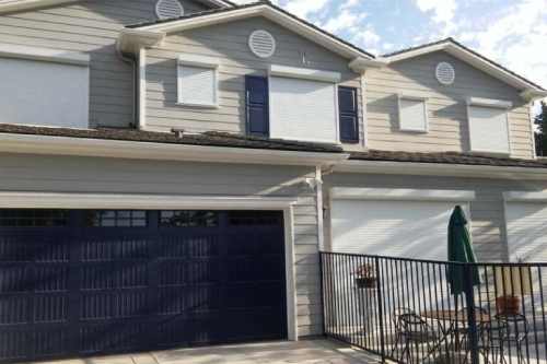 House with closed shutters and patio